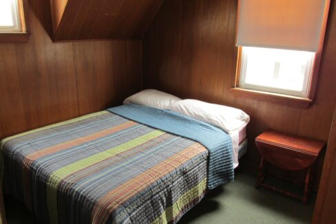 a bed sitting in a bedroom next to a window.