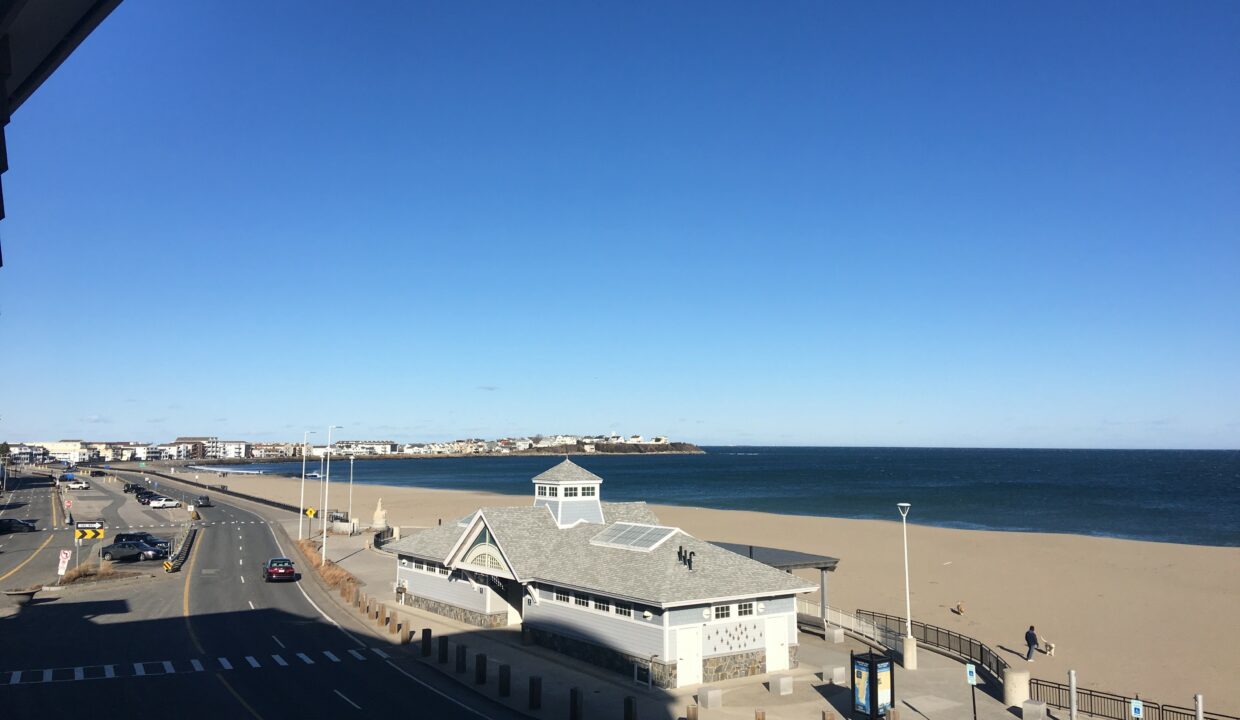 a view of a beach from a balcony of a building.