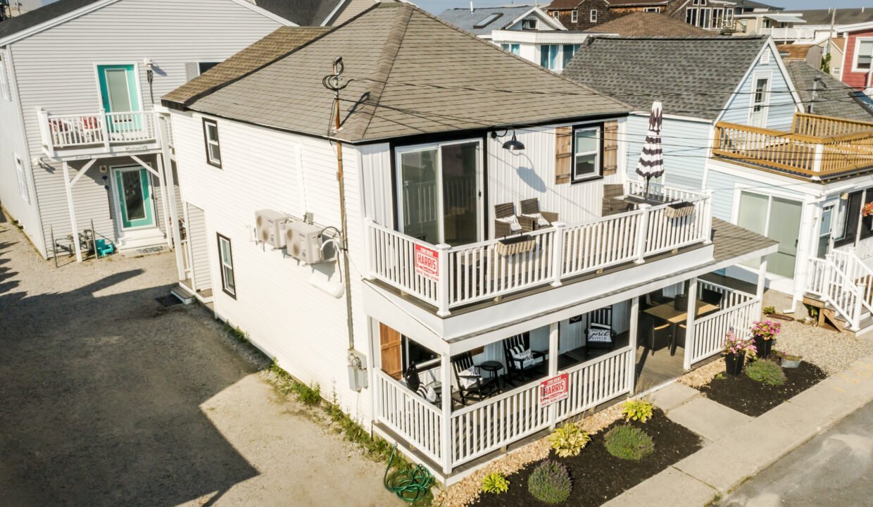 An aerial view of a beach house with a balcony.