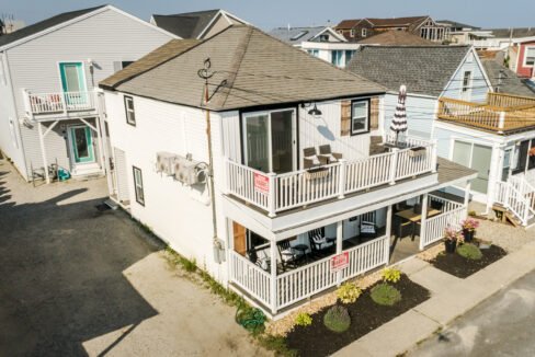 An aerial view of a beach house with a balcony.