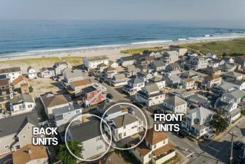 An aerial view of a house with a beach in the background.