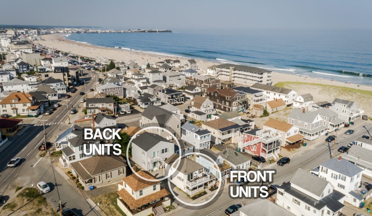 An aerial view of a neighborhood with houses and a beach.