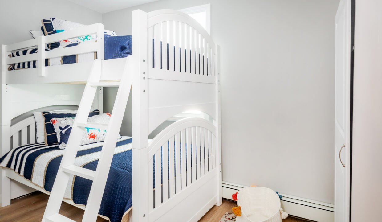 A white bunk bed with a ladder.