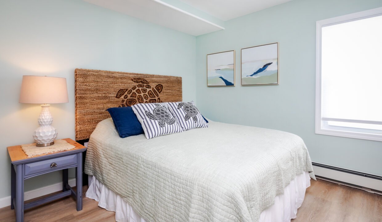 A bedroom with blue walls and a wooden bed.