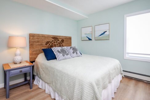 A bedroom with blue walls and a wooden bed.