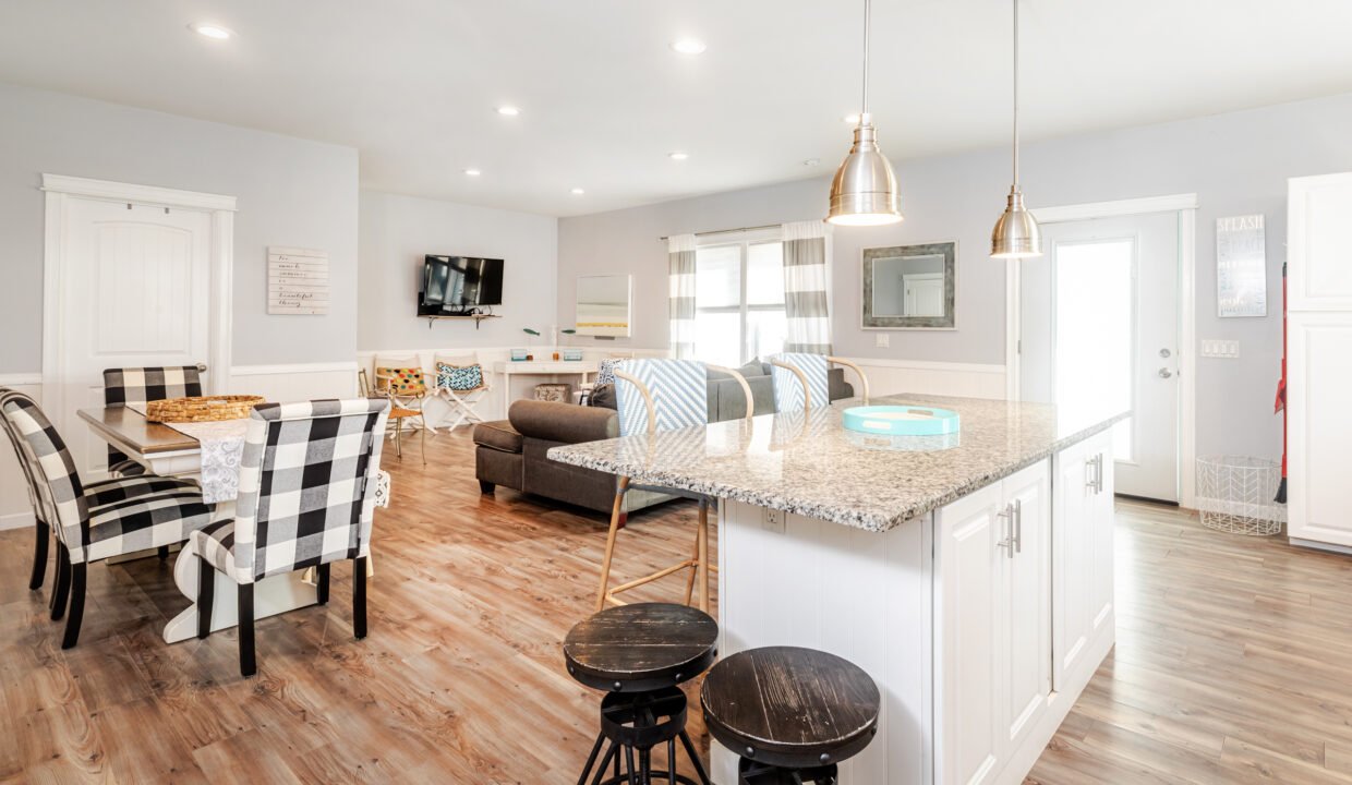 A kitchen, dining room and living room in a home.