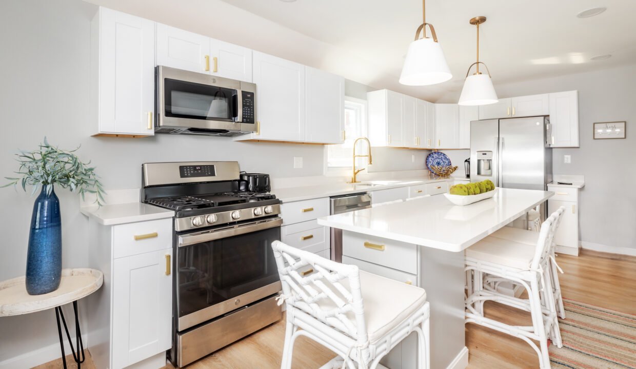 A kitchen with white cabinets and stainless steel appliances.