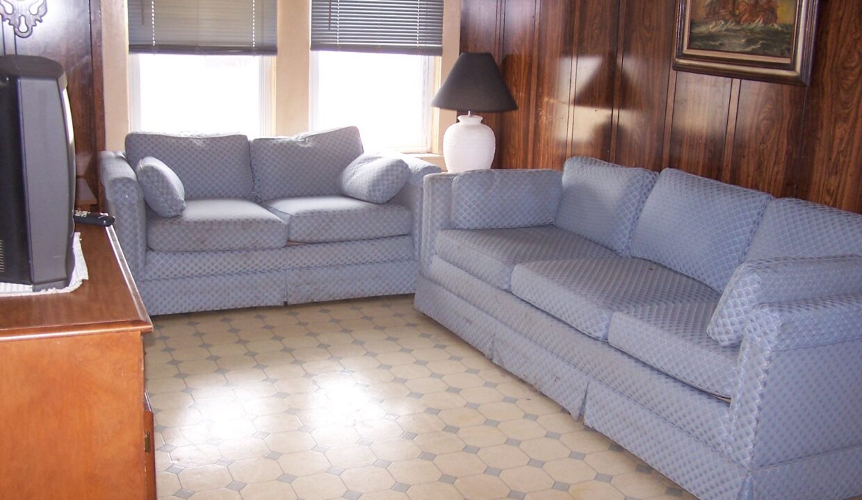 a living room filled with furniture and a flat screen tv.