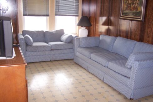 a living room filled with furniture and a flat screen tv.