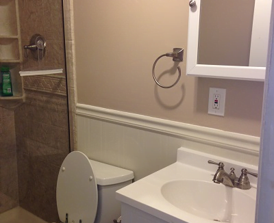 a white toilet sitting next to a white sink.