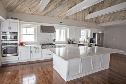 a large white kitchen with a center island.