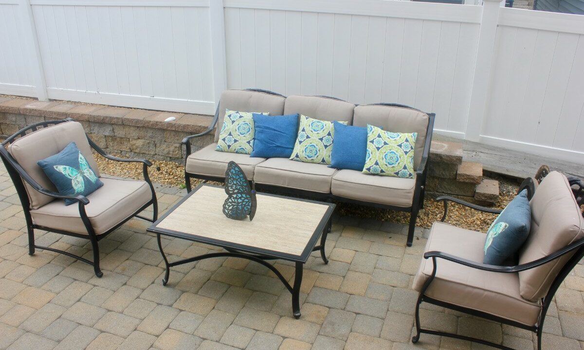 a set of patio furniture sitting on a brick patio.