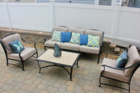 a set of patio furniture sitting on a brick patio.