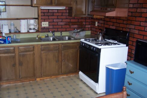a kitchen with a stove top oven next to a sink.