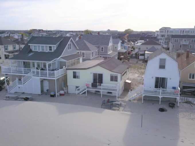 an aerial view of a beach town with houses.