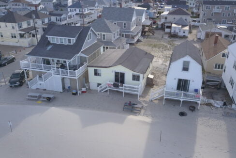 an aerial view of houses on a beach.