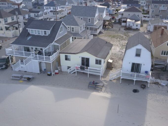 an aerial view of houses on a beach.