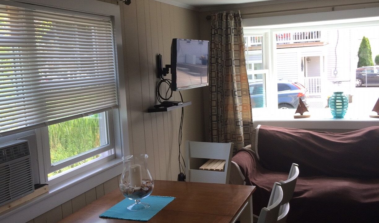 a living room filled with furniture and a flat screen tv.