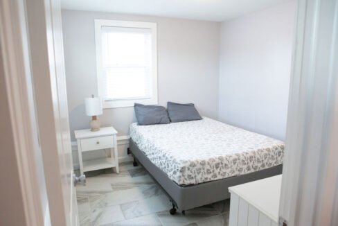 a bed sitting in a bedroom next to a window.