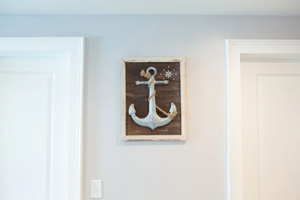 a picture of an anchor hanging on a wall.