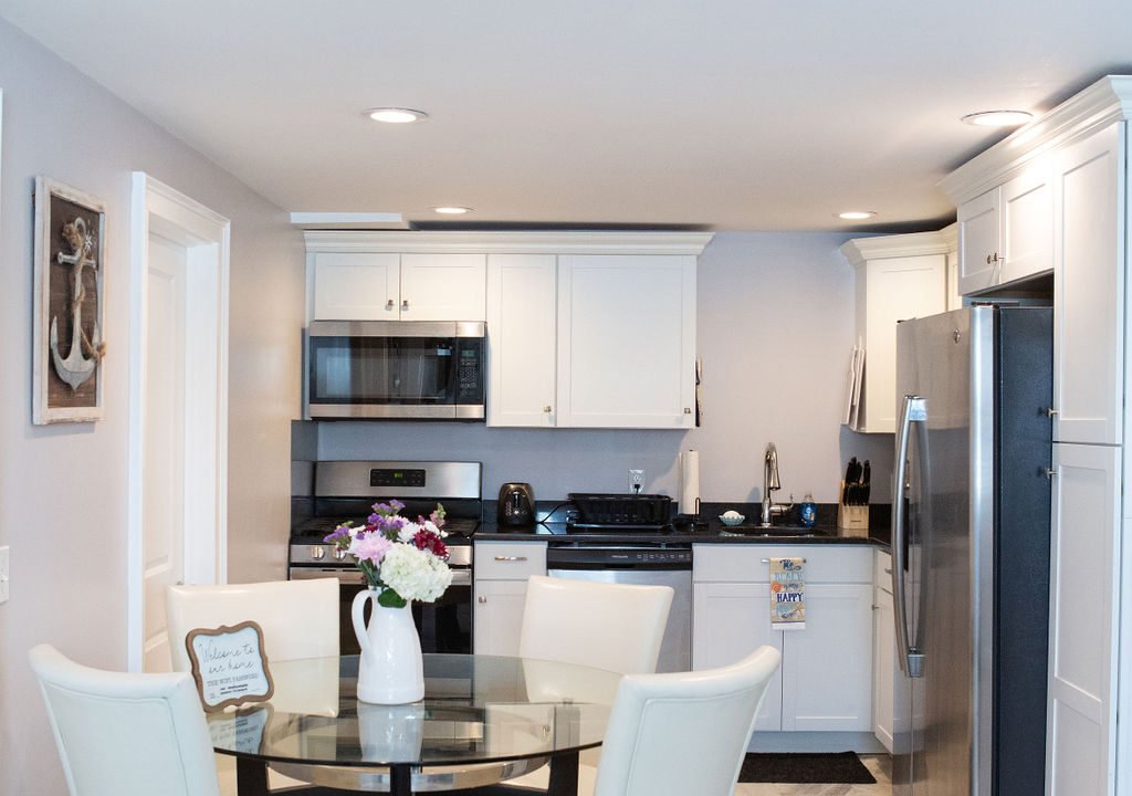 a kitchen with a table and chairs and a refrigerator.