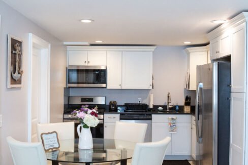 a kitchen with a table and chairs and a refrigerator.