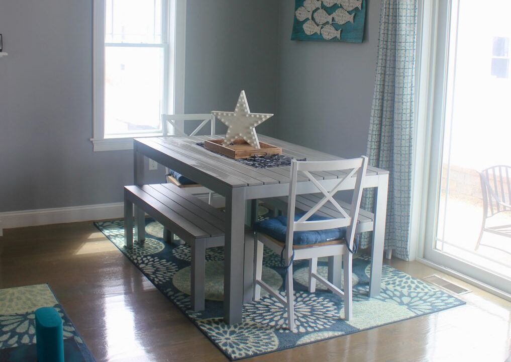 a dining room with a table and chairs.