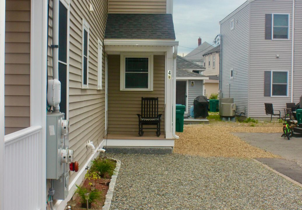 a house with a gravel driveway next to it.