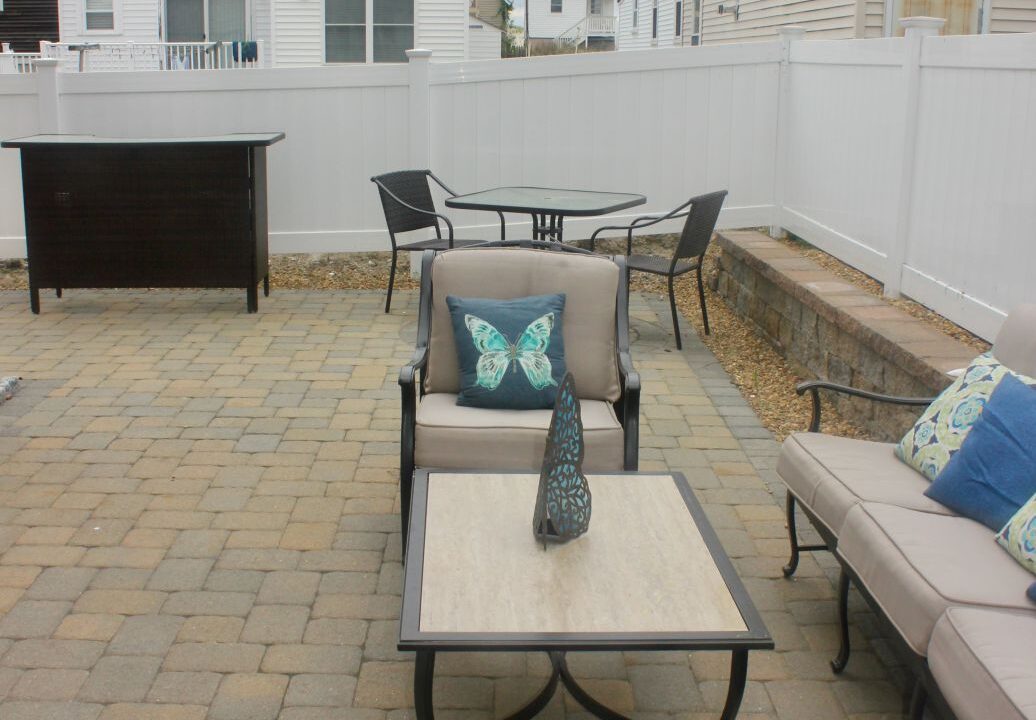 a patio with a couch, table and chairs.