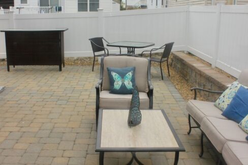 a patio with a couch, table and chairs.