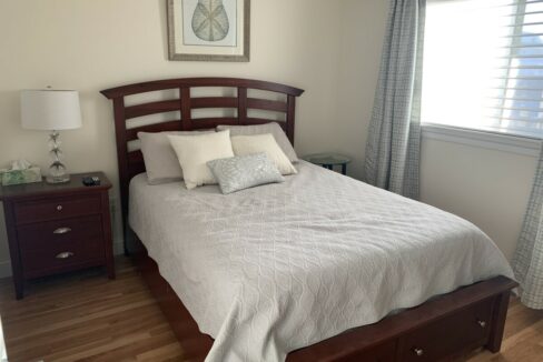 a bed sitting in a bedroom next to a window.