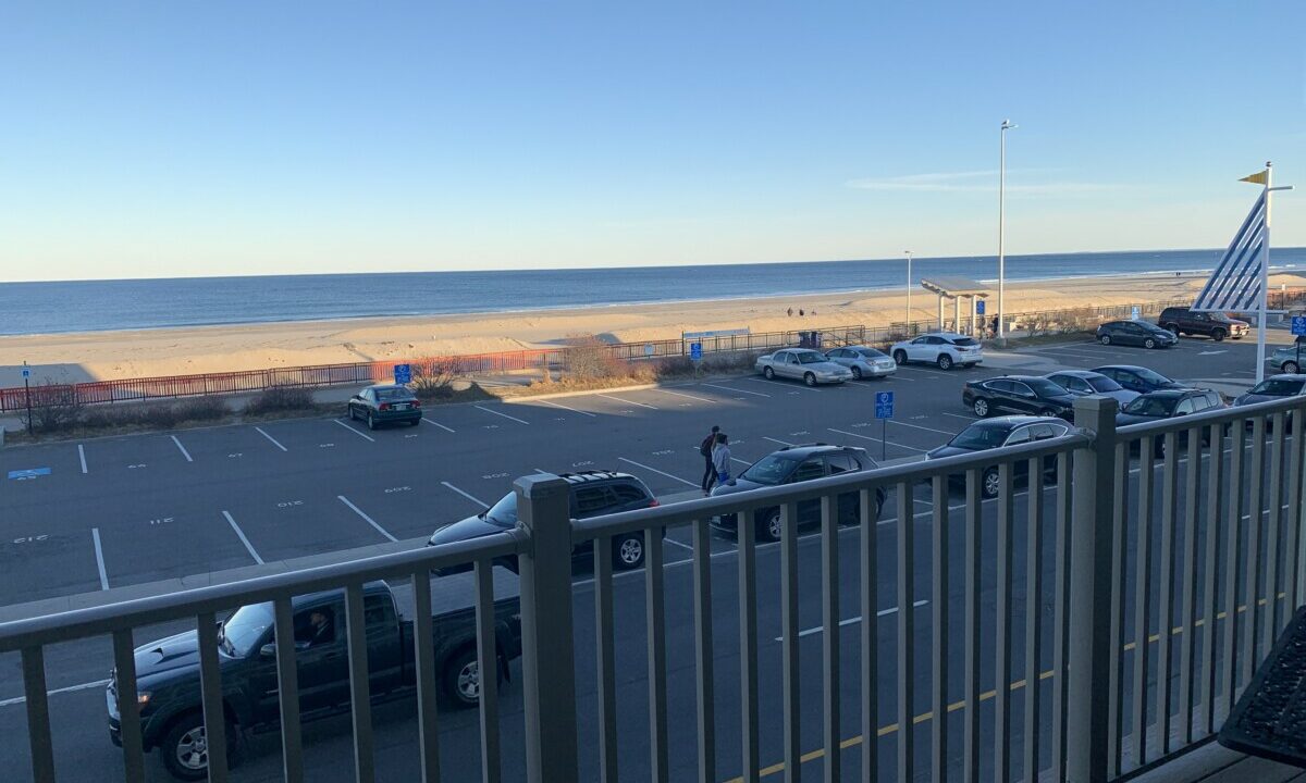 a view of a parking lot from a balcony.