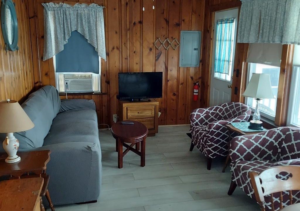 a living room filled with furniture and a flat screen tv.