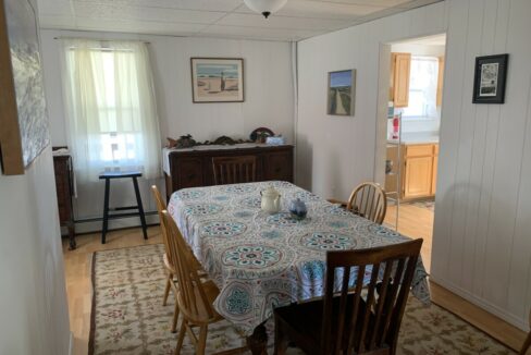 a dining room with a table and chairs.