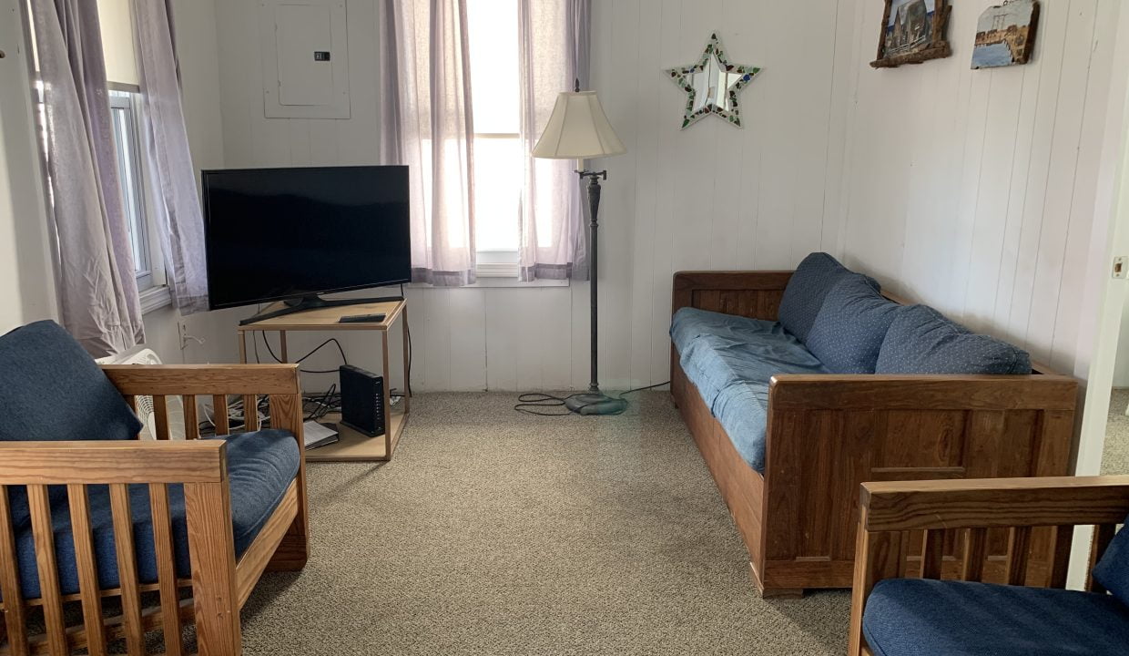 a living room filled with furniture and a flat screen tv.