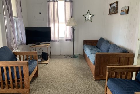 a living room filled with furniture and a flat screen tv.