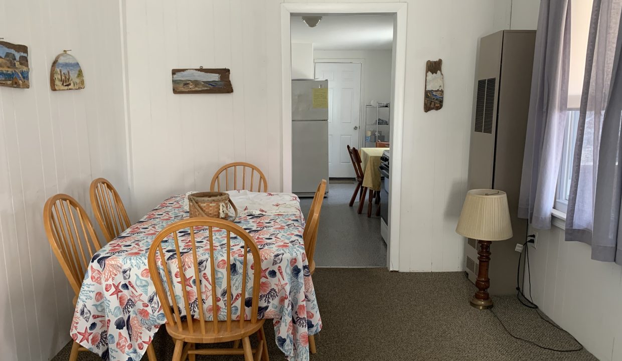 a dining room with a table and chairs.
