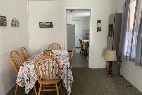 a dining room with a table and chairs.