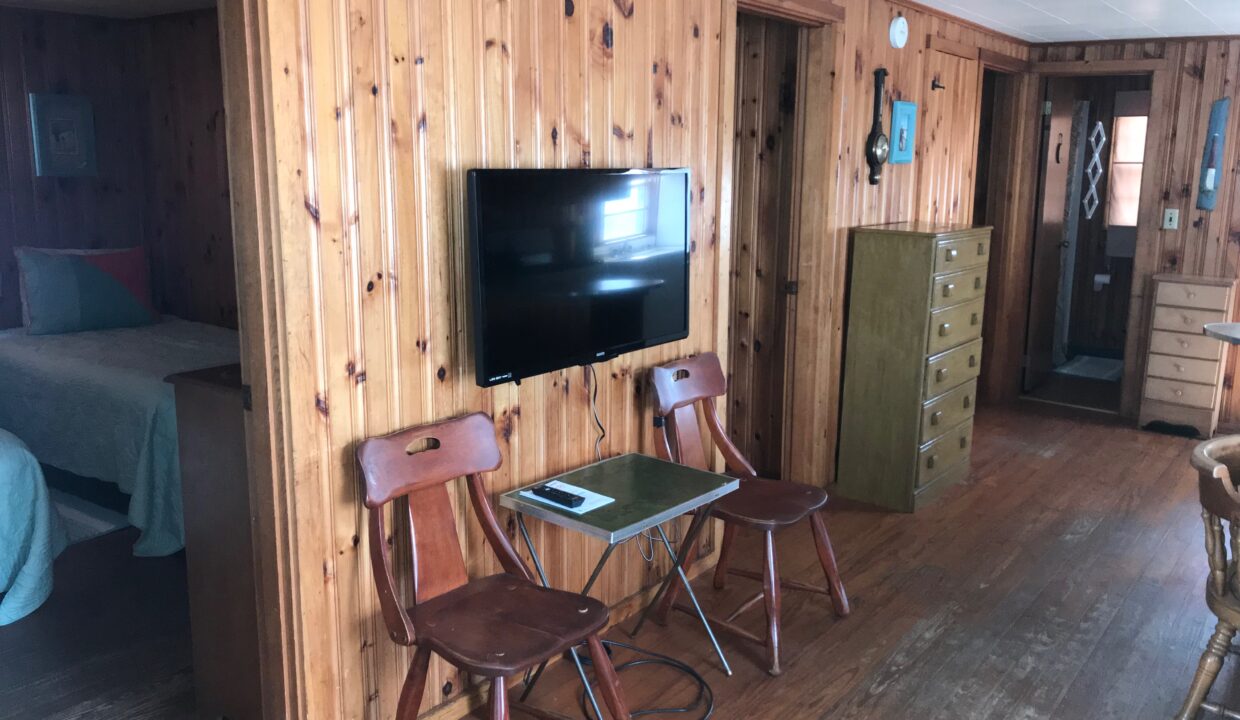 a room with wooden walls and a flat screen tv.