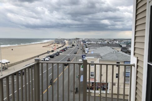 a balcony with a view of the beach and ocean.