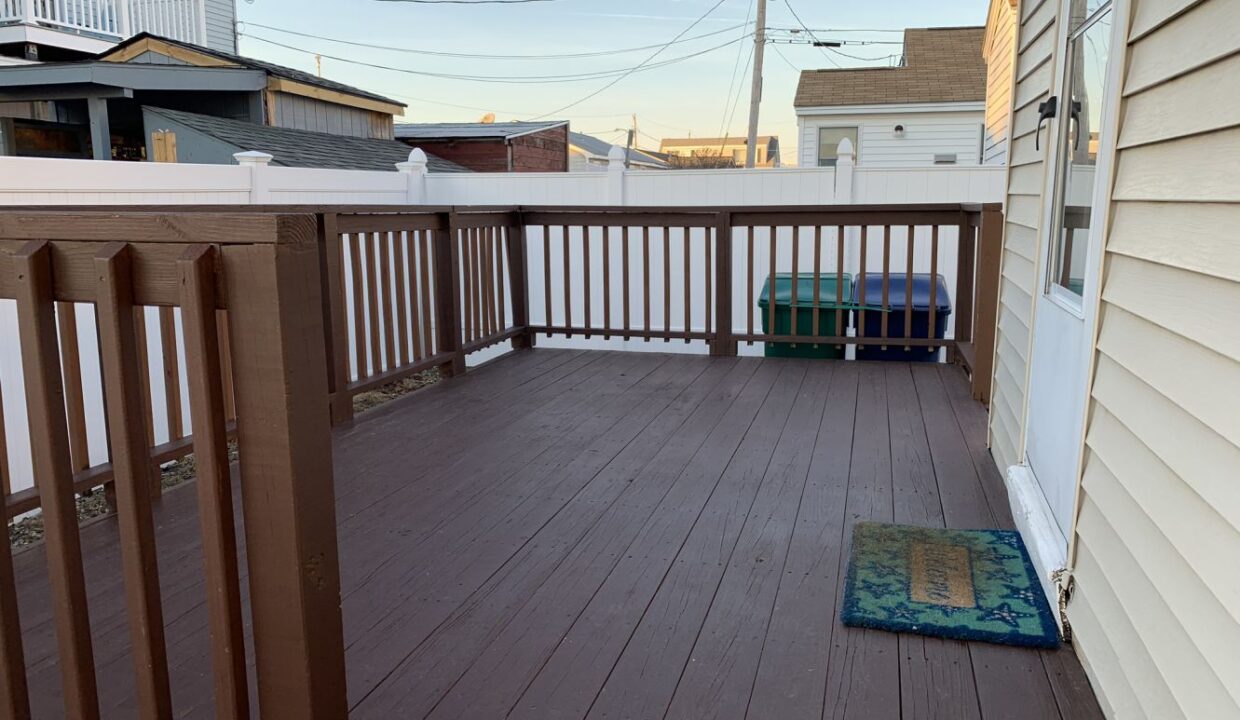 a wooden deck with a rug on it.