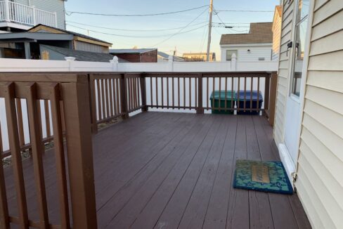 a wooden deck with a rug on it.