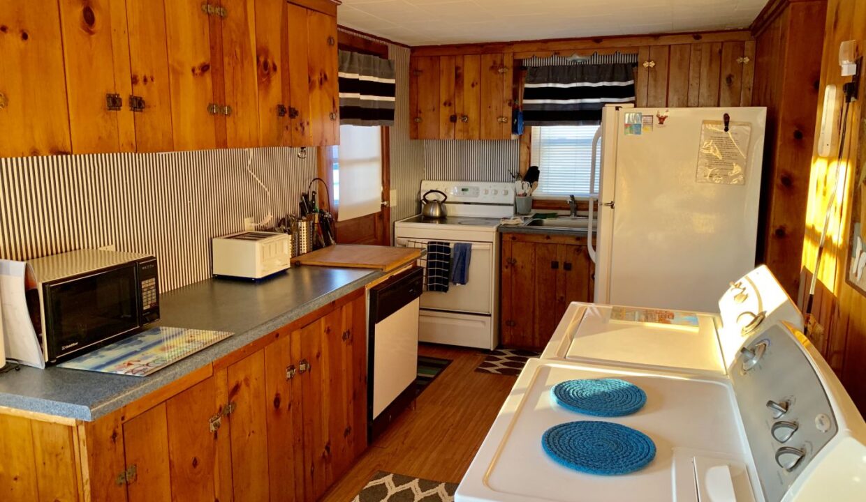 a kitchen with wood paneling and white appliances.
