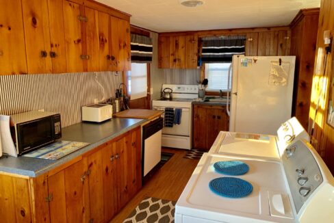 a kitchen with wood paneling and white appliances.