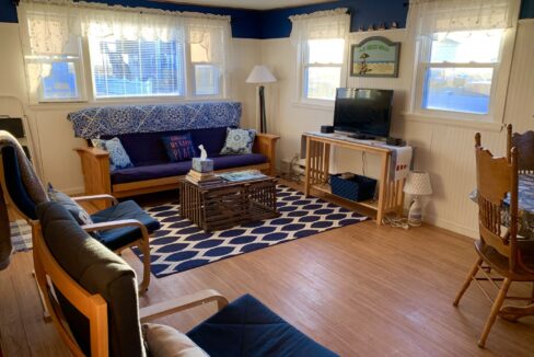 a living room filled with furniture and a flat screen tv.