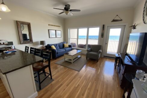 a living room filled with furniture and a flat screen tv.