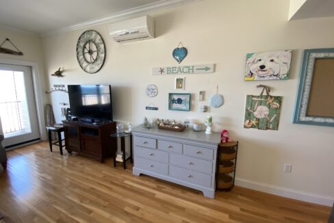 a living room filled with furniture and a flat screen tv.