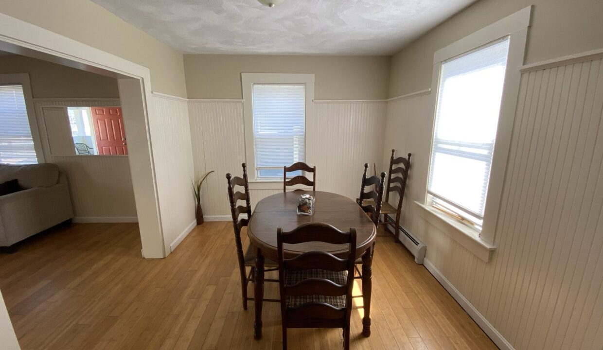 a dining room with a table and chairs.