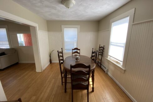a dining room with a table and chairs.