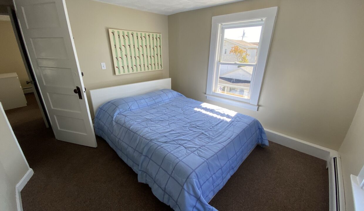 a bed sitting in a bedroom next to a window.